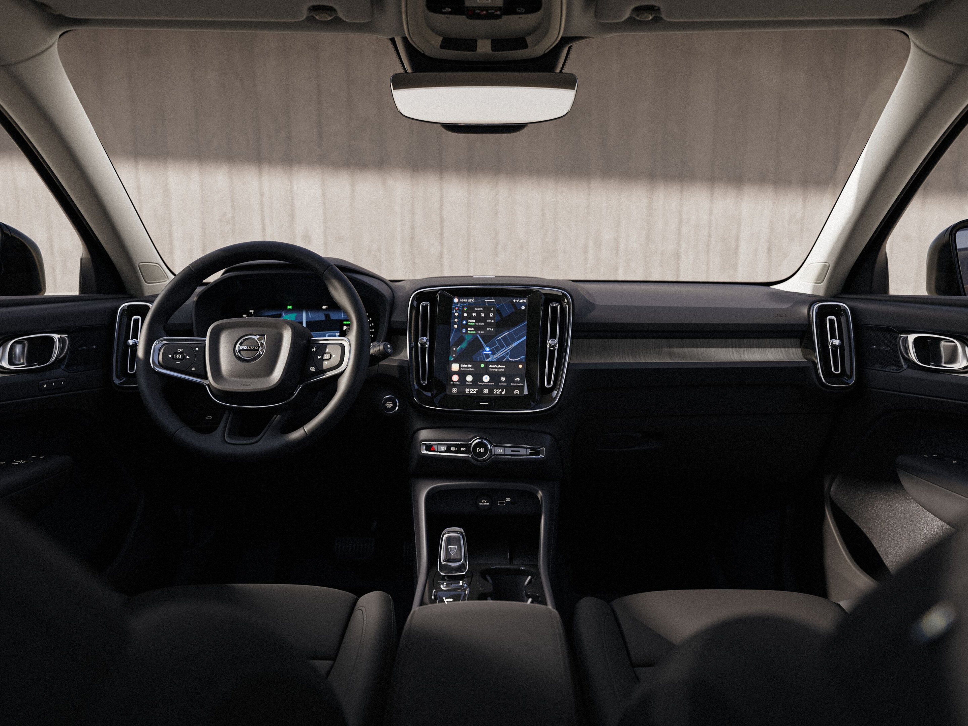 沃尔沃 XC40 内部仪表盘视图,包括方向盘和触摸屏。