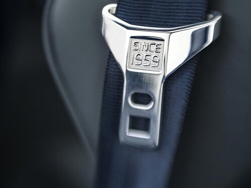 A safety belt in grey with the text “Since 1959” engraved on the buckle.